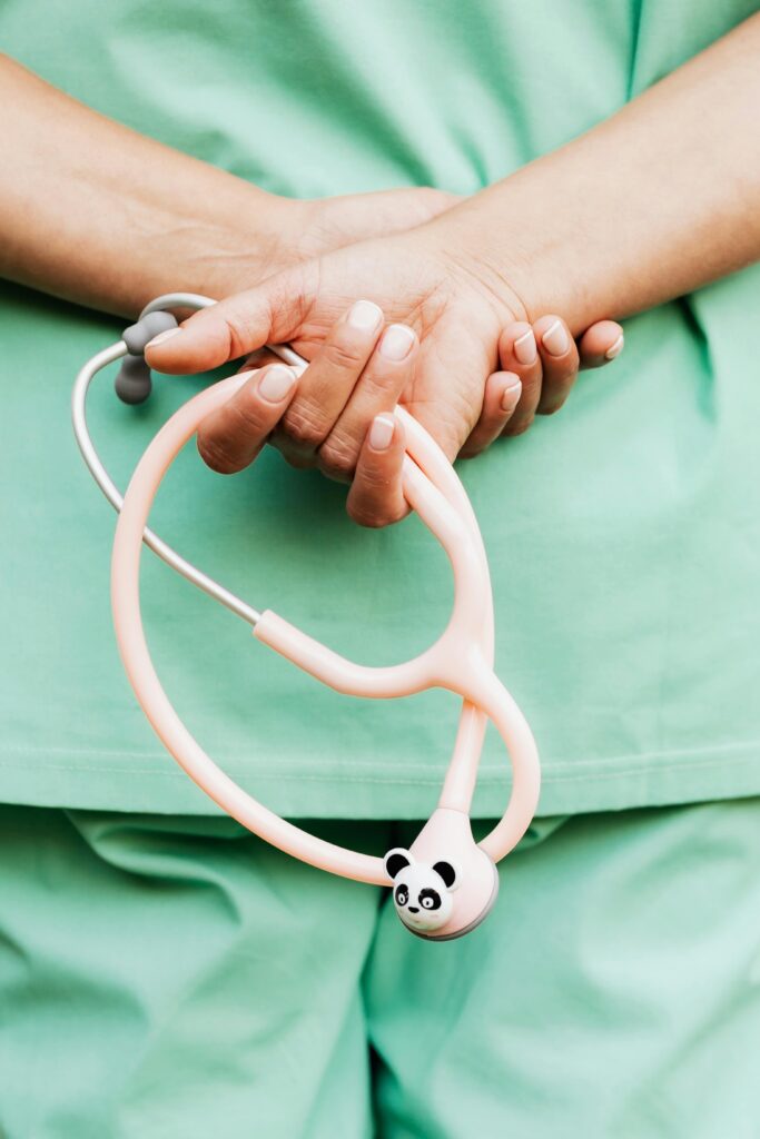 Close-up of a medical professional holding a panda-themed stethoscope, showcasing healthcare tools.